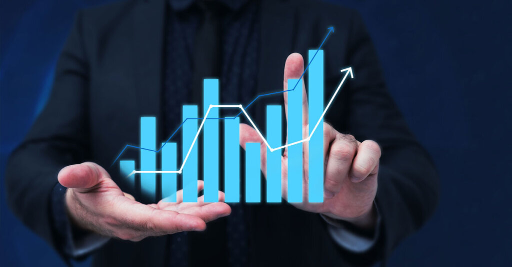 A bar chart held in a pair of hand